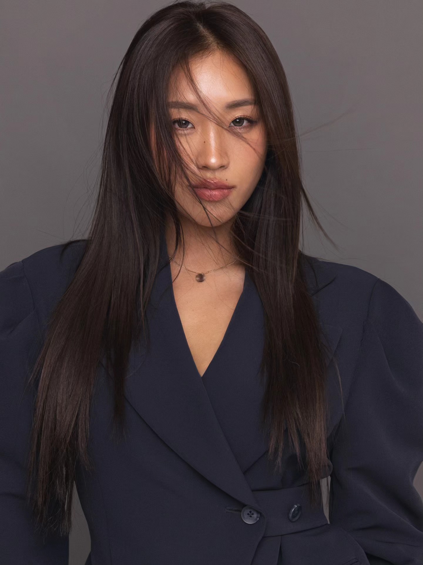 Navy blazer, motion in hair